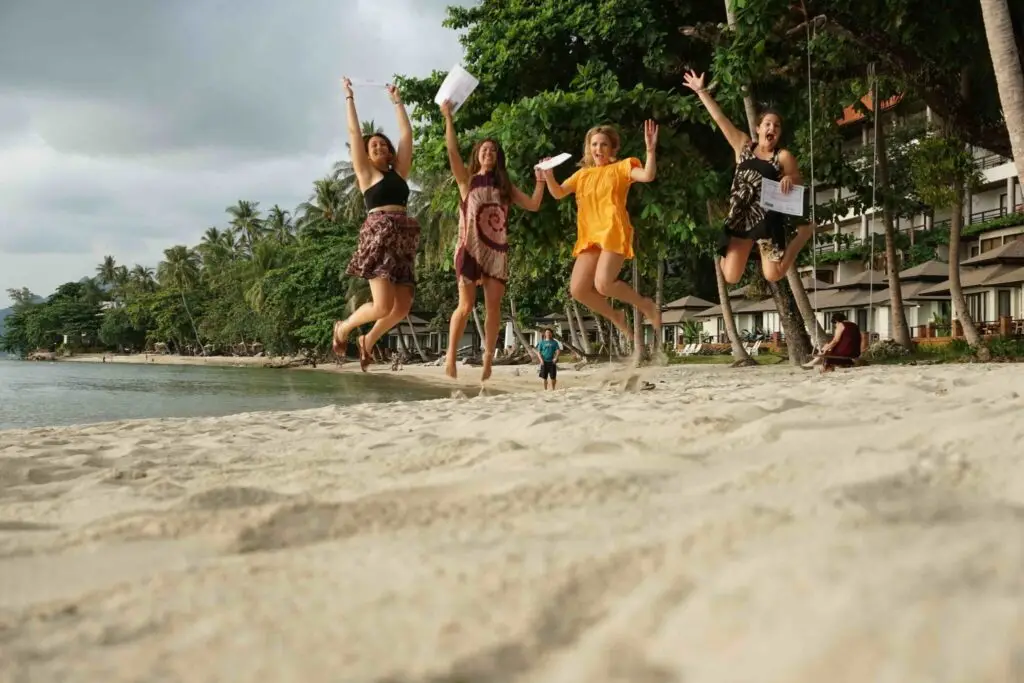 DSC01402 Group of friends jumping on a beach in Thailand during teaching abroad experience