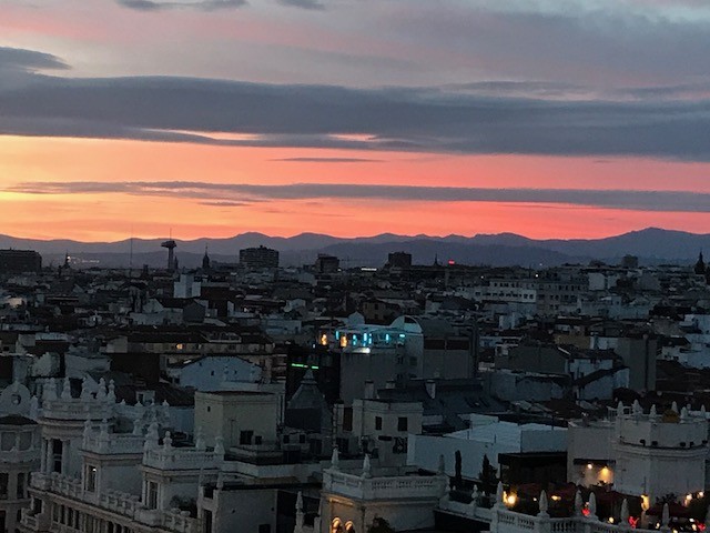 IMG_0166 Sunset over Madrid skyline with city buildings and mountains in the distance