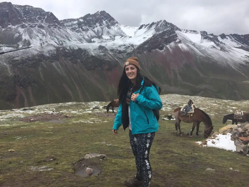 IMG_0627 Woman standing in mountain landscape in Peru with snow-capped peaks