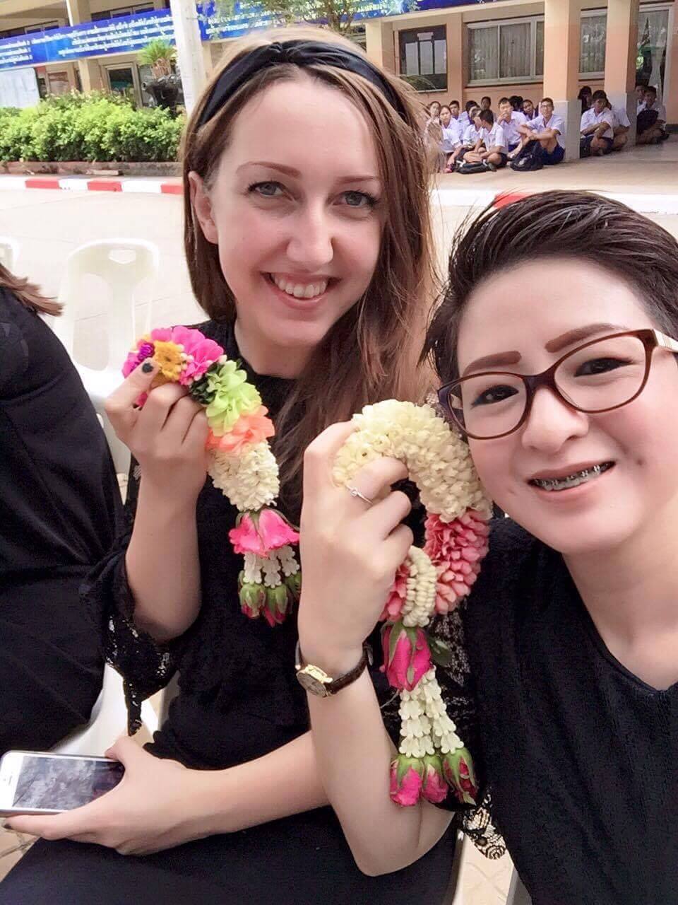 IMG_2147 Teacher smiling with Thai colleague holding flower garlands