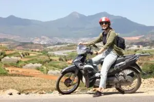 IMG_2986 Woman riding motorbike in rural mountain landscape in Vietnam