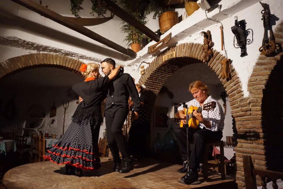 TEFL1 Flamenco dancers performing with guitarist in traditional Spanish setting