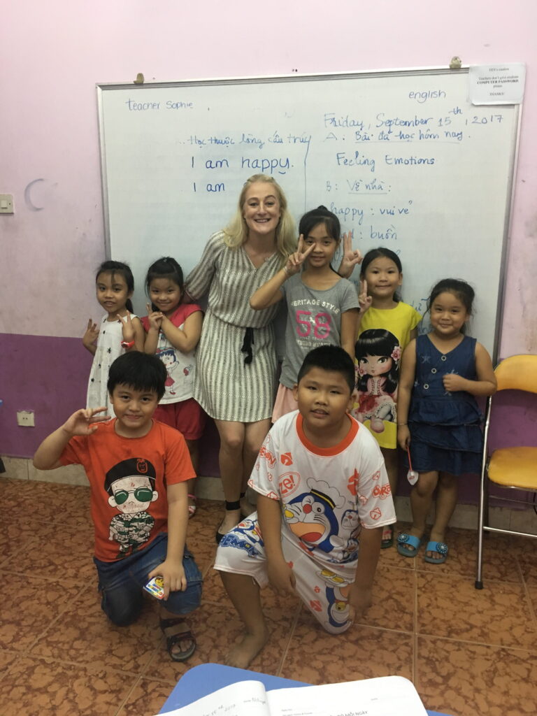 image2 Teacher standing with young students in classroom in Vietnam
