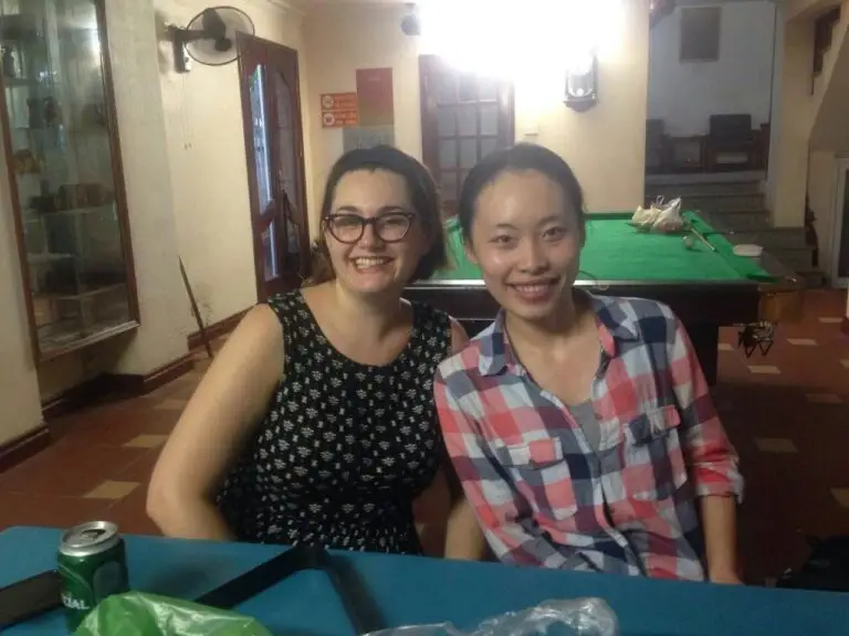 mmexport1501417530631 Teacher and local friend sitting together indoors in Vietnam smiling at the camera