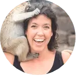 stef-g.png Smiling woman posing with a monkey on her shoulder in Thailand